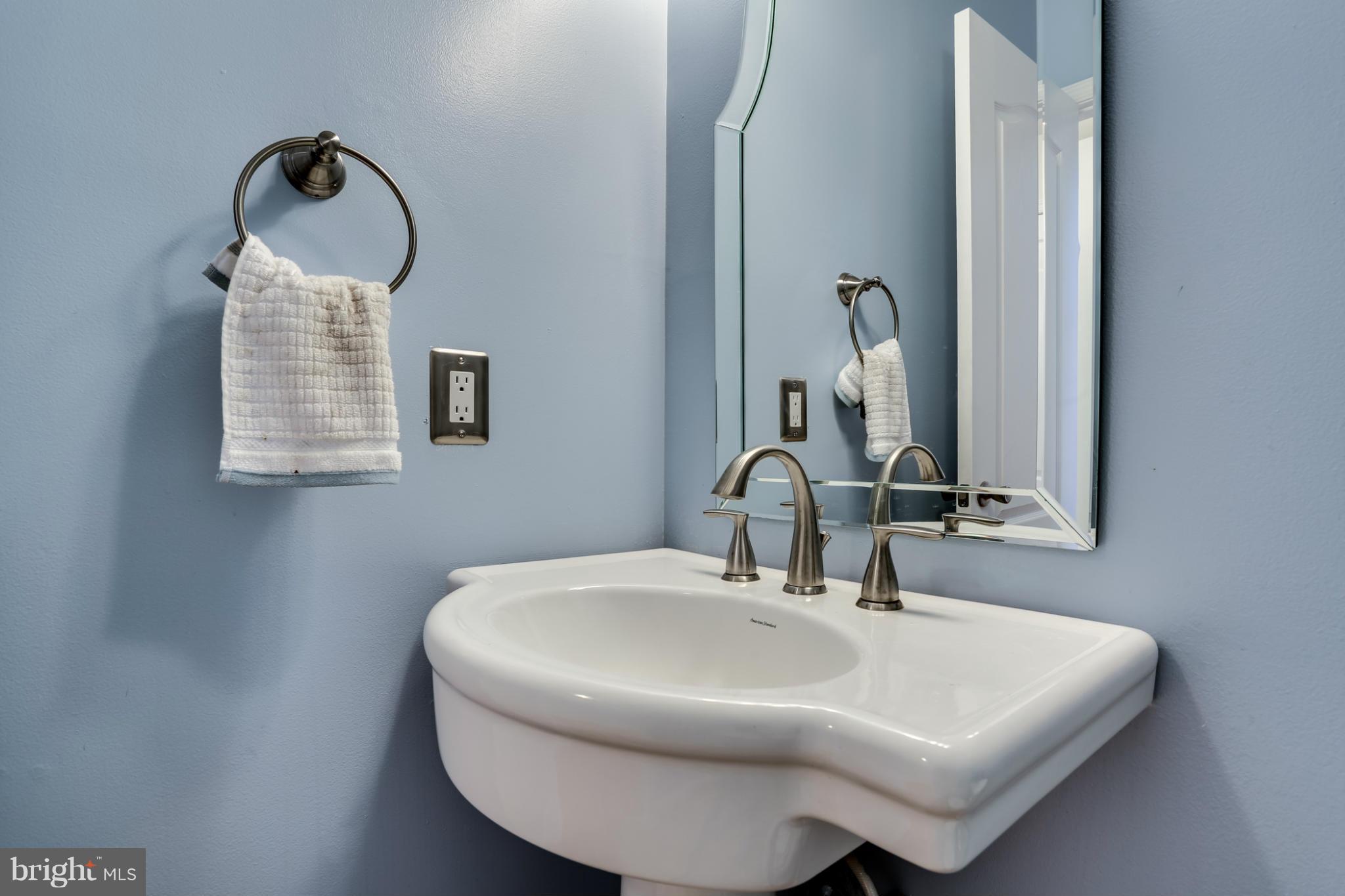 6814 North Stuart Road King George, VA 22485 - Photo 16 of 30 a bathroom with a sink and a mirror