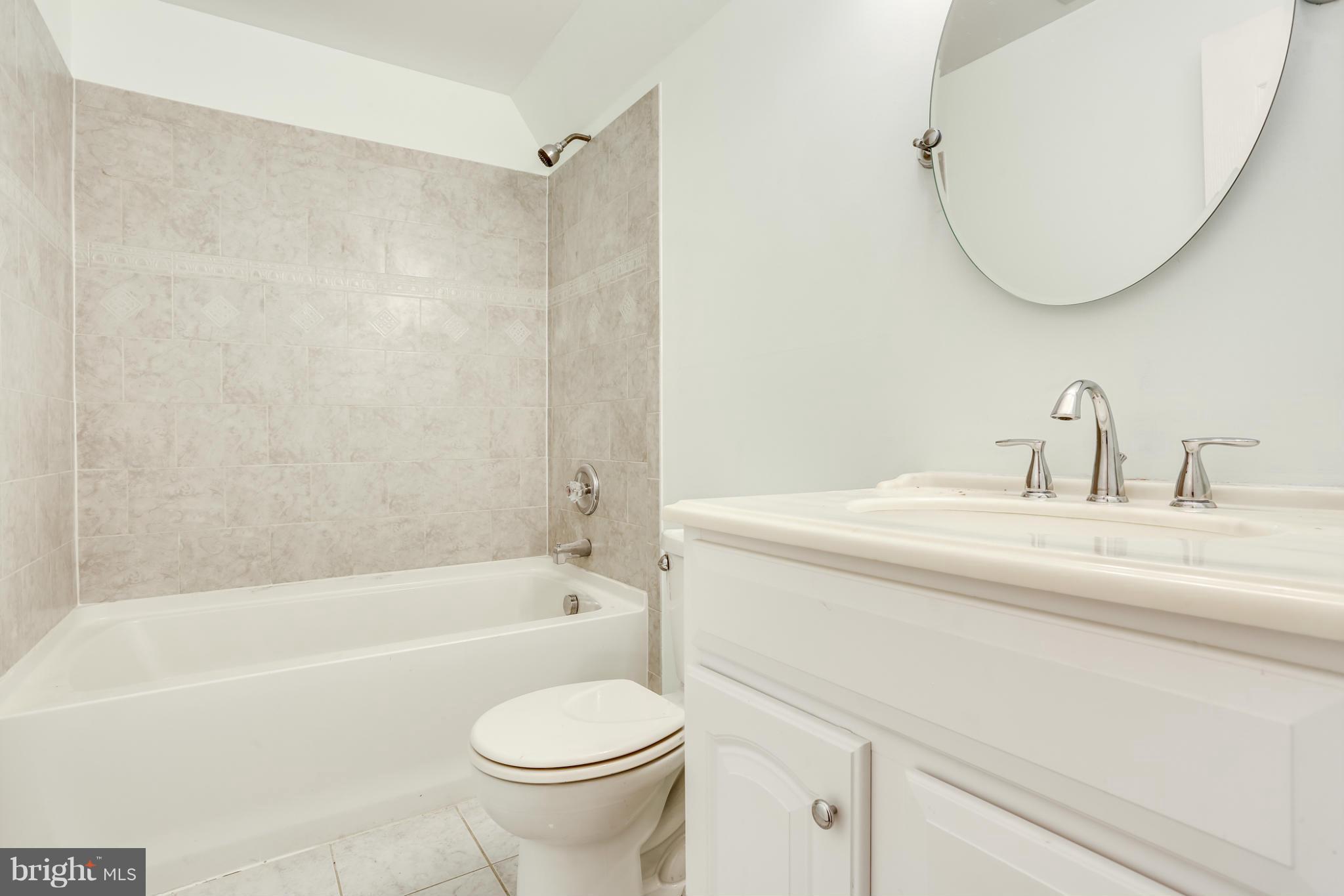 6814 North Stuart Road King George, VA 22485 - Photo 17 of 30 a bathroom with a sink a toilet and a bathtub