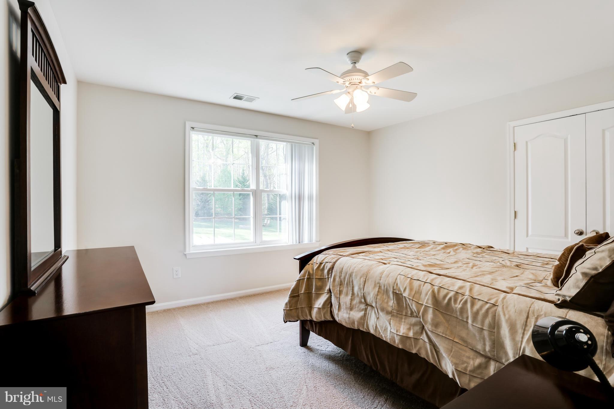 6814 North Stuart Road King George, VA 22485 - Photo 18 of 30 a bedroom with a bed and a window
