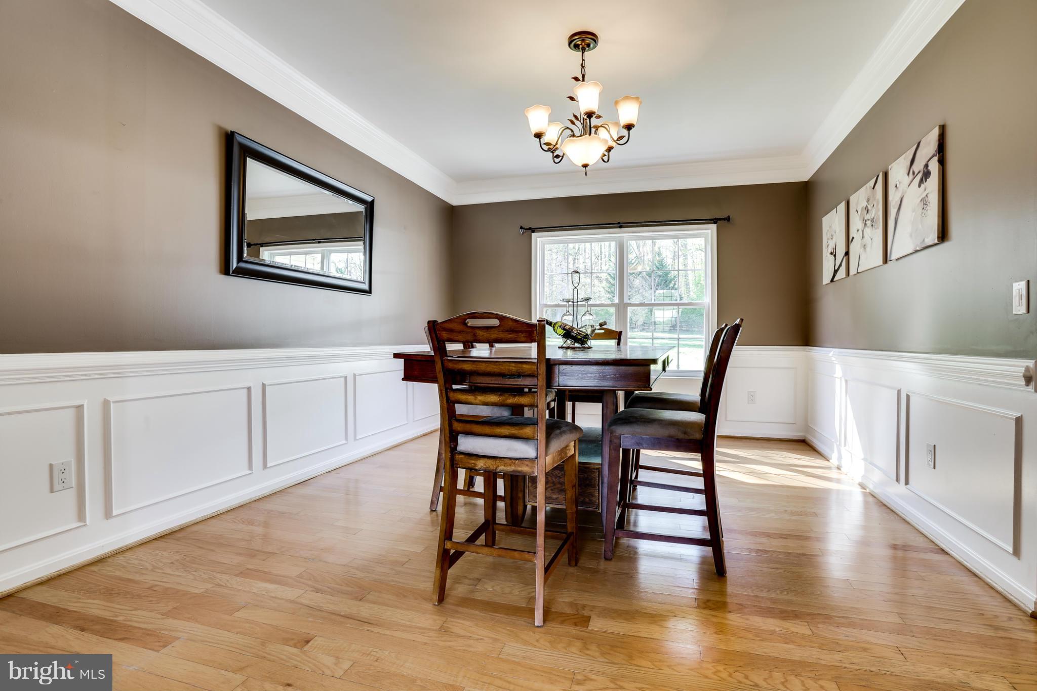 6814 North Stuart Road King George, VA 22485 - Photo 5 of 30 a view of a dining room with furniture window and wooden floor