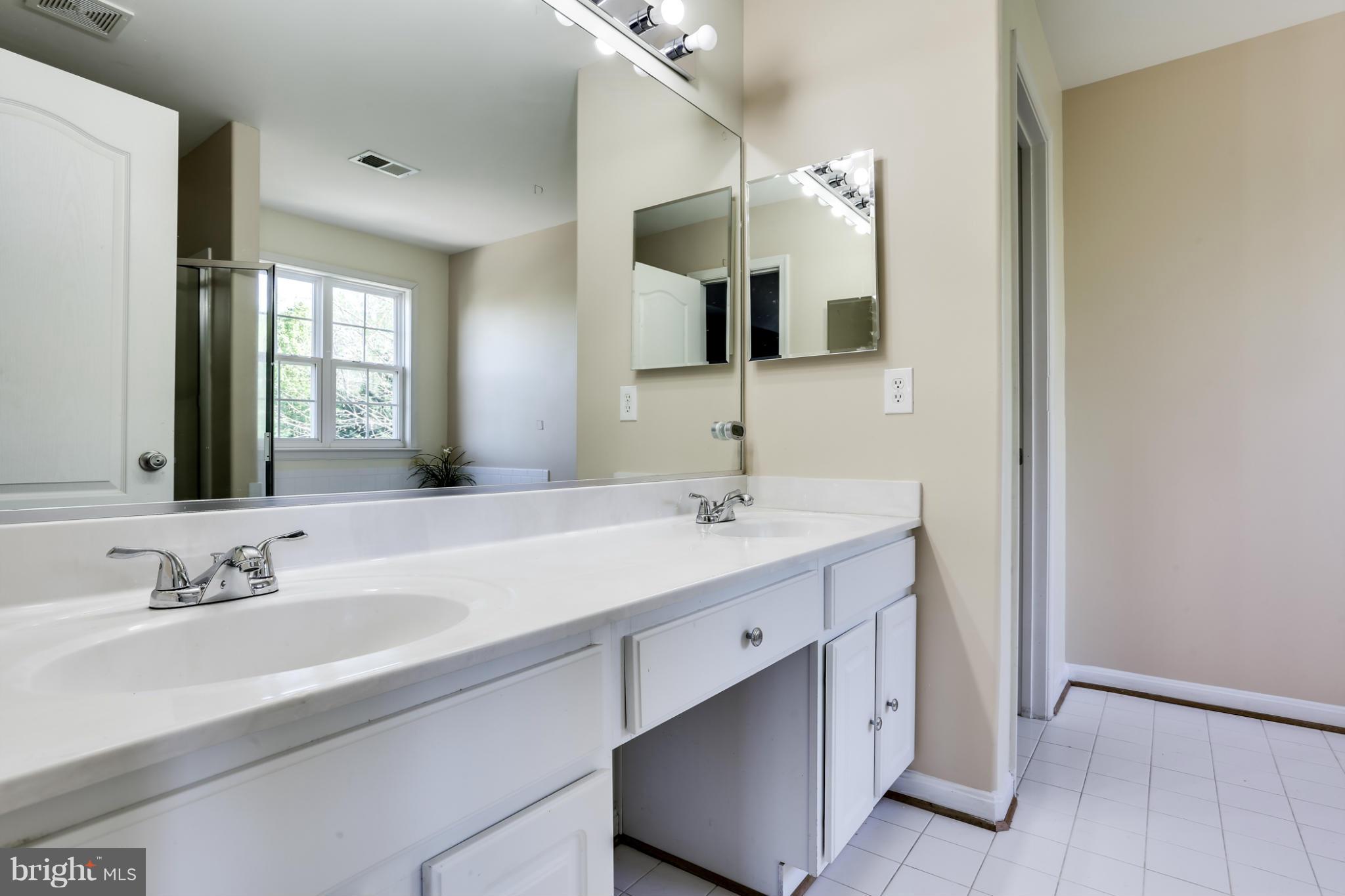 6814 North Stuart Road King George, VA 22485 - Photo 6 of 30 a bathroom with a double vanity sink mirror and