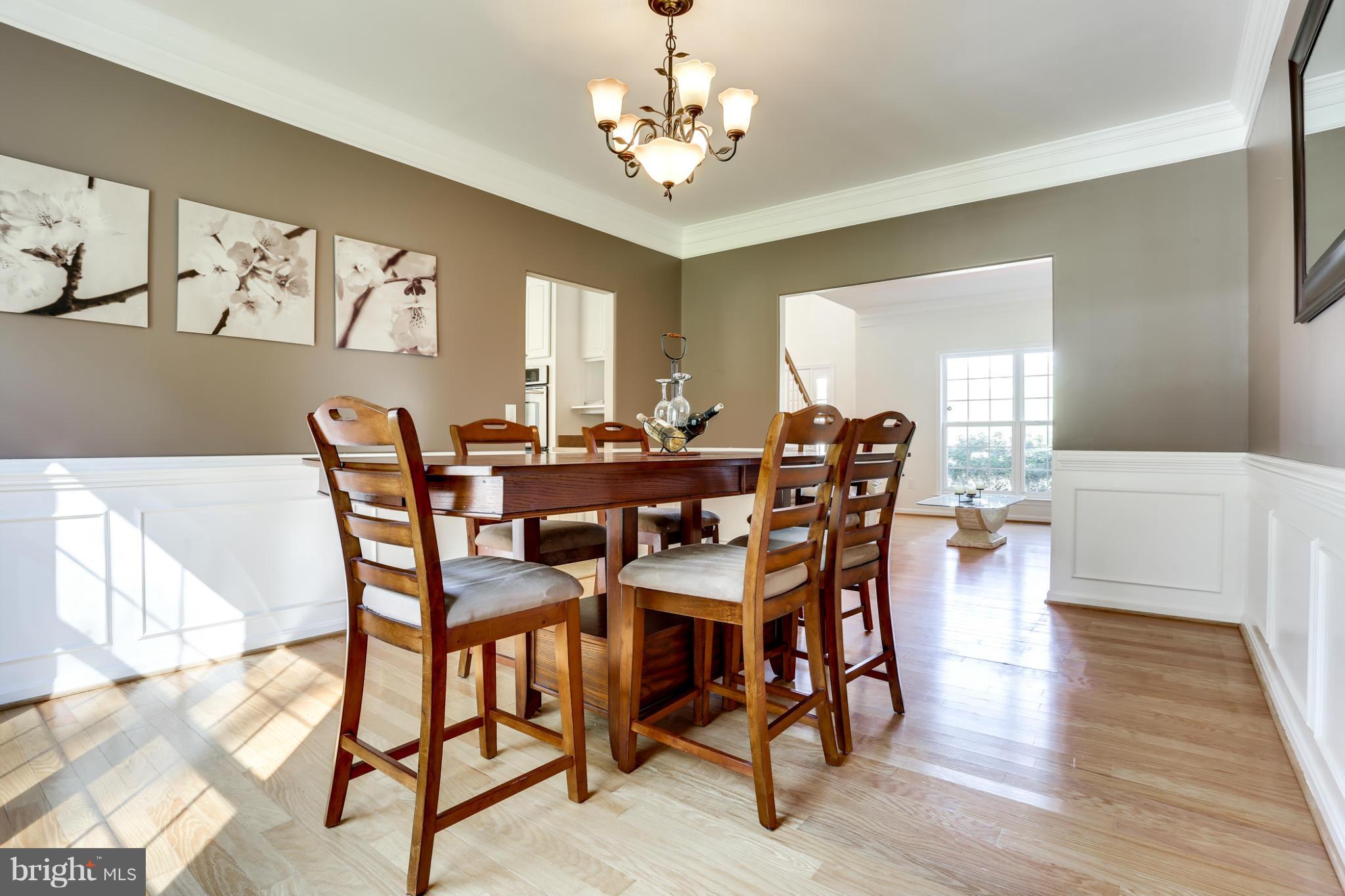 6814 North Stuart Road King George, VA 22485 - Photo 10 of 30 a view of a dining room with furniture and wooden floor