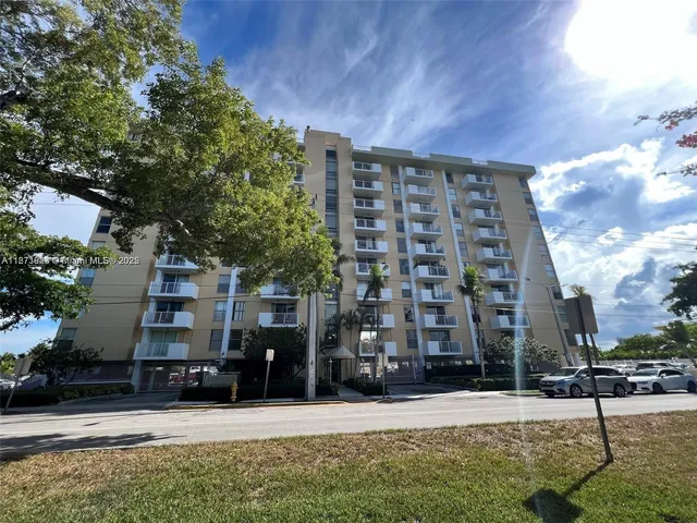 a front view of a building with a garden
