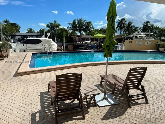 swimming pool view with a seating space