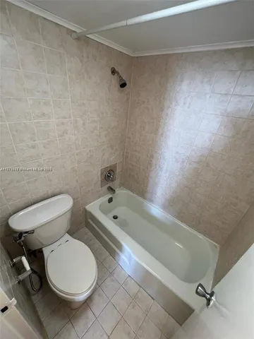 a bathroom with a toilet a sink and bathtub