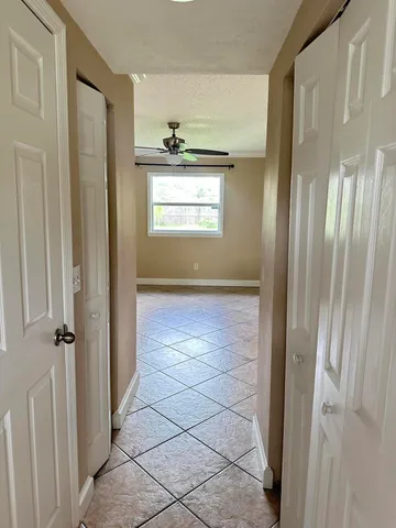 a view of hallway with window and front door