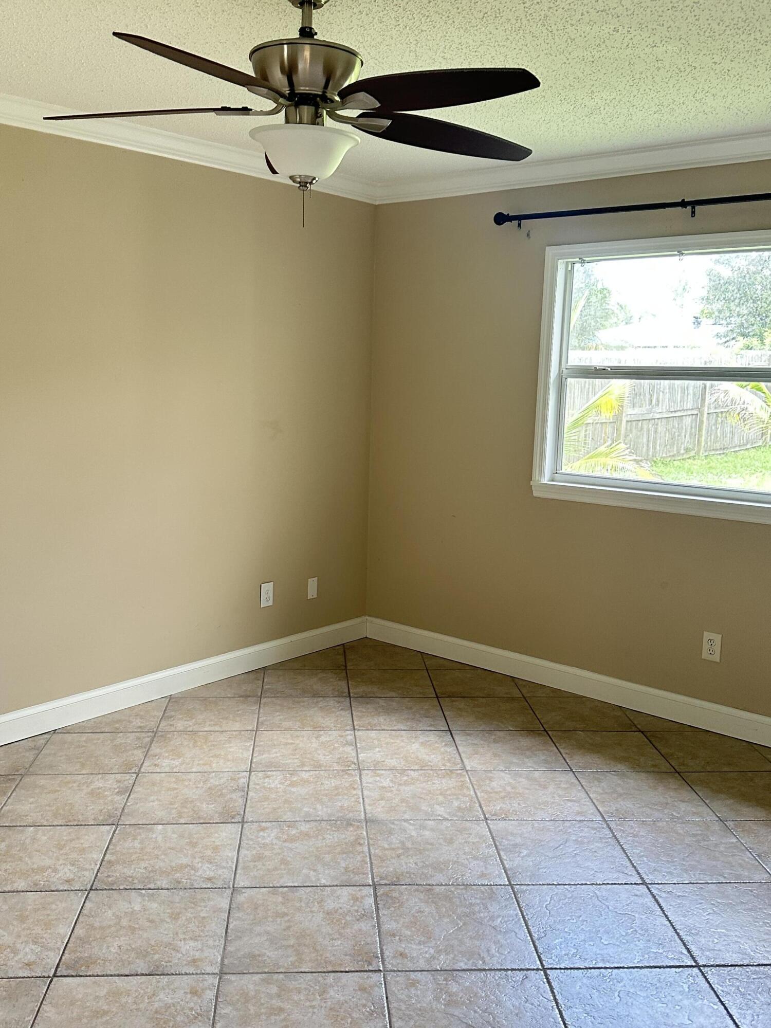 383 Southwest Tulip Boulevard Port St. Lucie, FL 34953 - Photo 21 of 26 a view of an empty room with a window