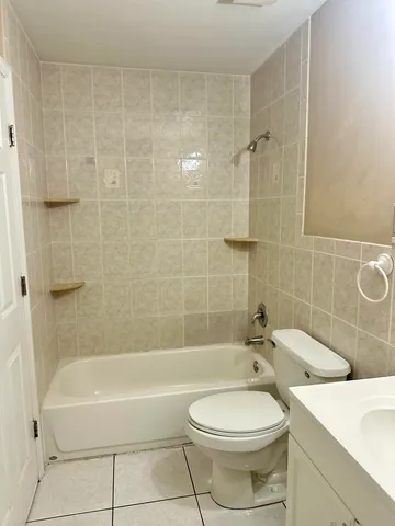 a bathroom with a toilet a sink and bathtub