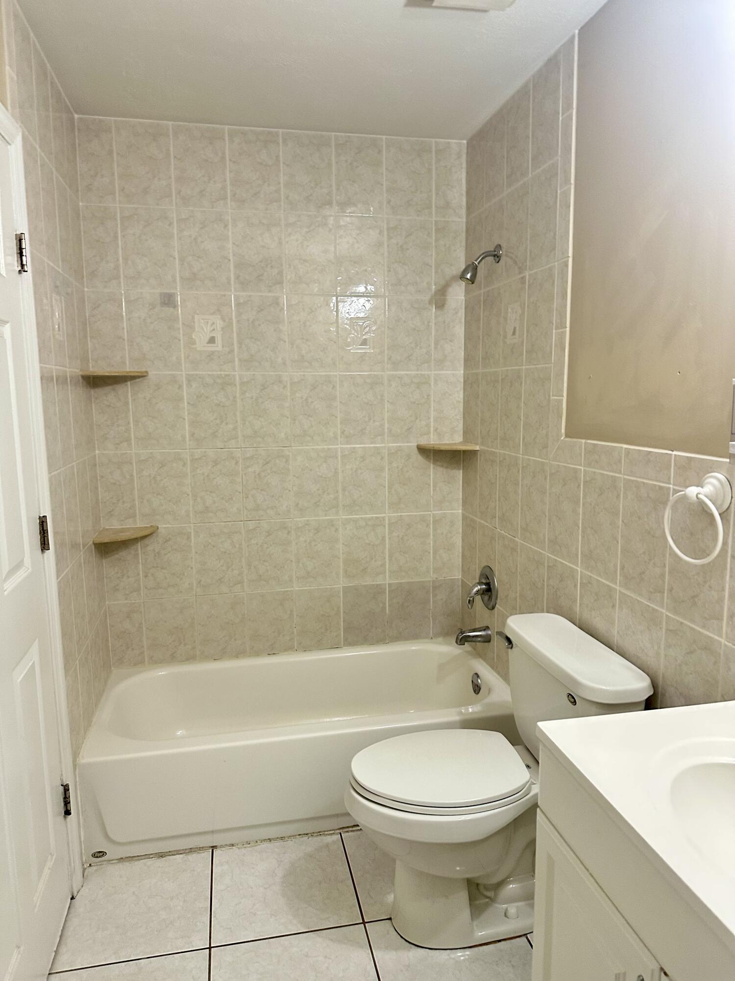 383 Southwest Tulip Boulevard Port St. Lucie, FL 34953 - Photo 22 of 26 a bathroom with a toilet a sink and bathtub