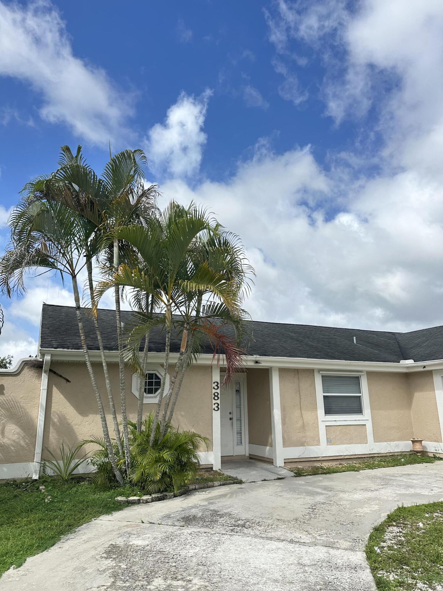 383 Southwest Tulip Boulevard Port St. Lucie, FL 34953 - Photo 25 of 26 a front view of a house with garden