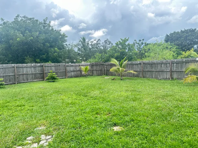a view of a backyard with a garden and entertaining space