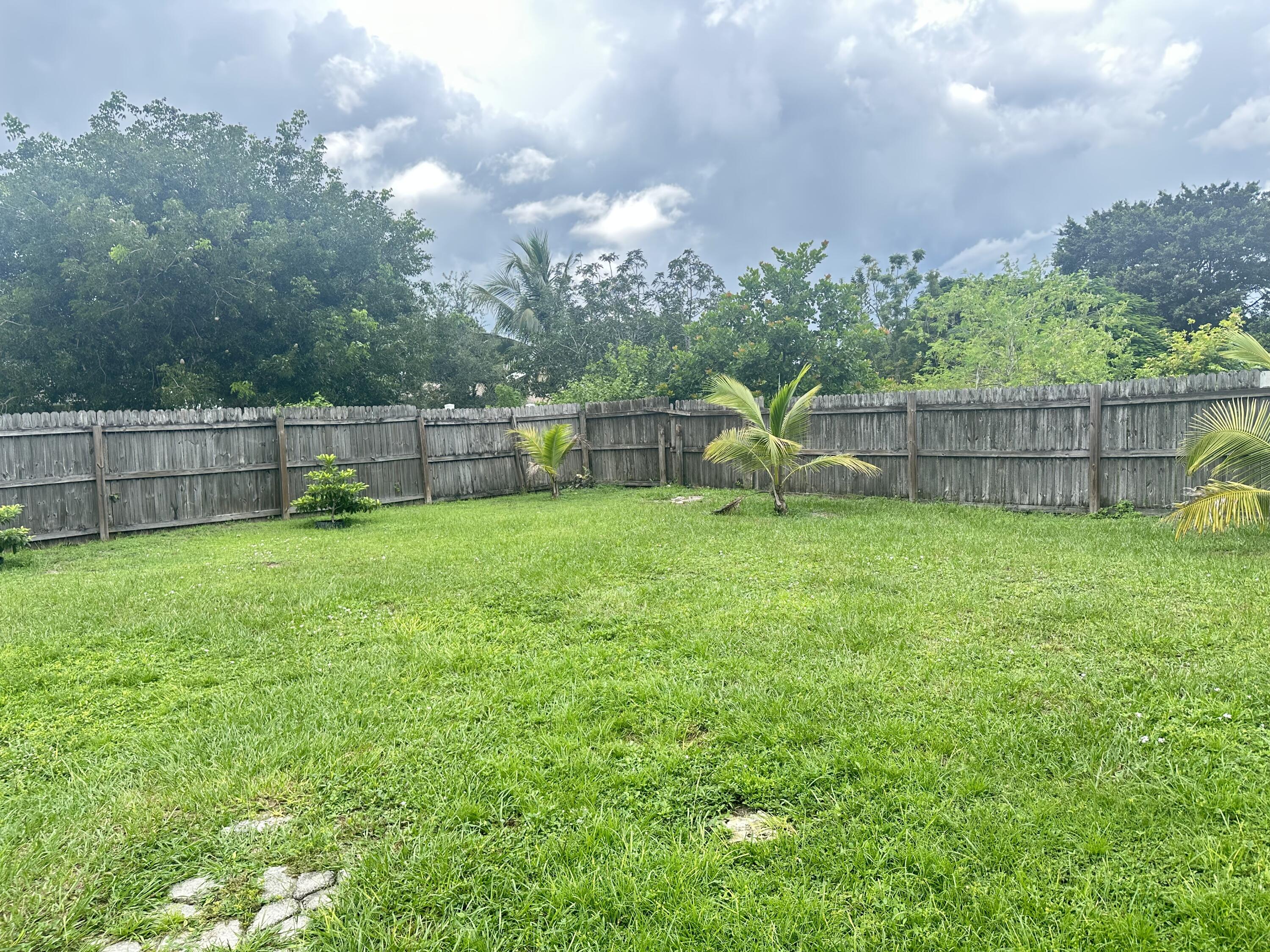 383 Southwest Tulip Boulevard Port St. Lucie, FL 34953 - Photo 26 of 26 a view of a backyard with a garden and entertaining space