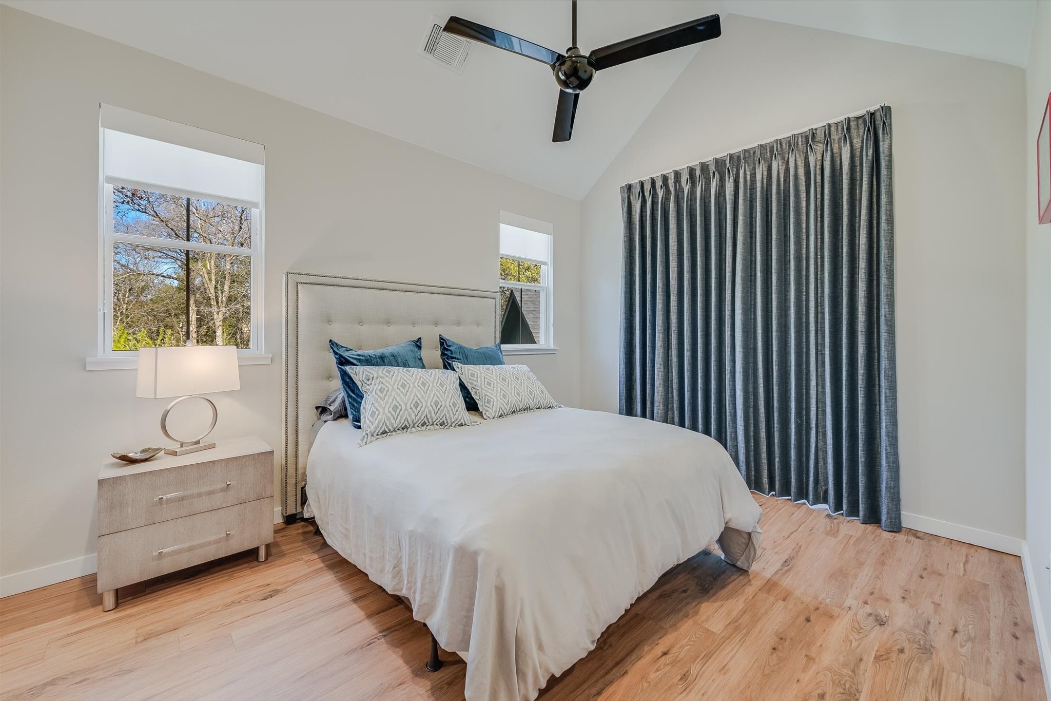 3809 Valley View Road, Unit 7 Austin, TX 78704 - Photo 11 of 21 Bedroom with vaulted ceiling, light hardwood / wood-style floors, and ceiling fan