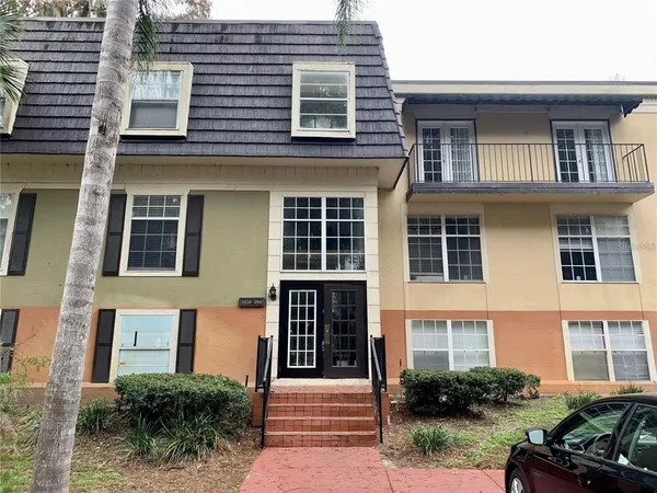 a front view of a house with plants