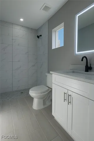 an empty room with a ceiling fan and window