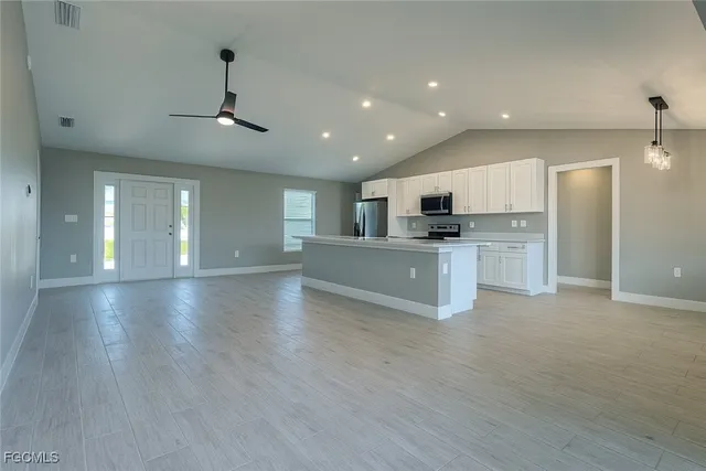 a view of a kitchen with a sink and a stove top oven