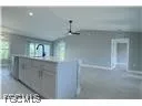 a kitchen with kitchen island a sink stainless steel appliances and cabinets