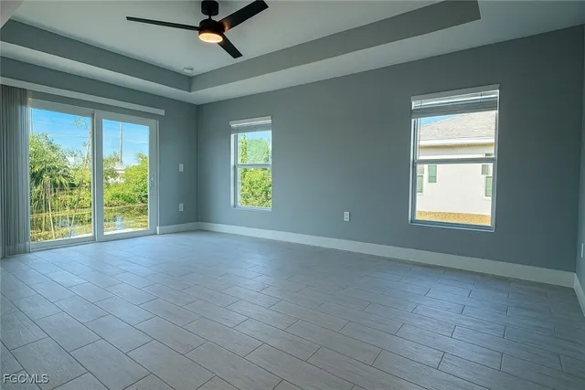 an empty room with closet and windows