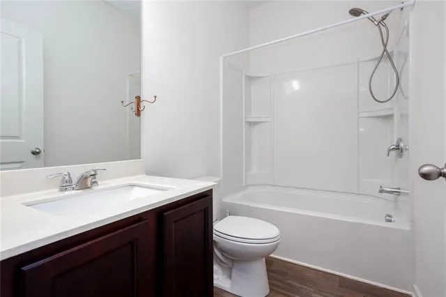 a large kitchen with stainless steel appliances granite countertop a stove a sink and a microwave