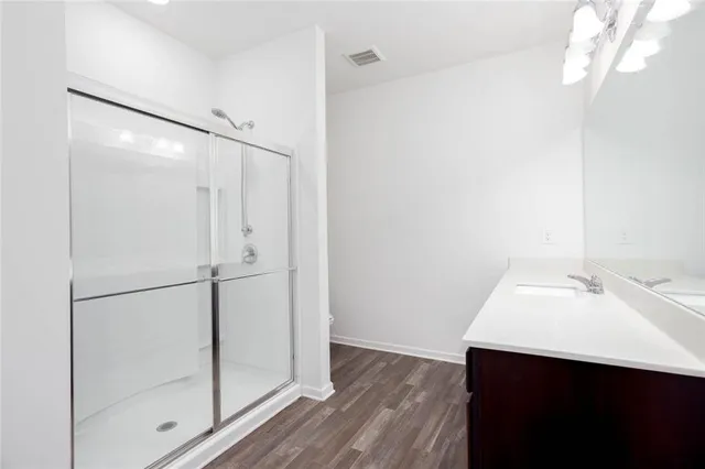 a bathroom with a glass shower door