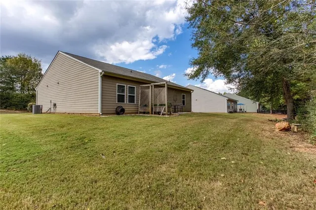 a backyard of a house with table and chairs