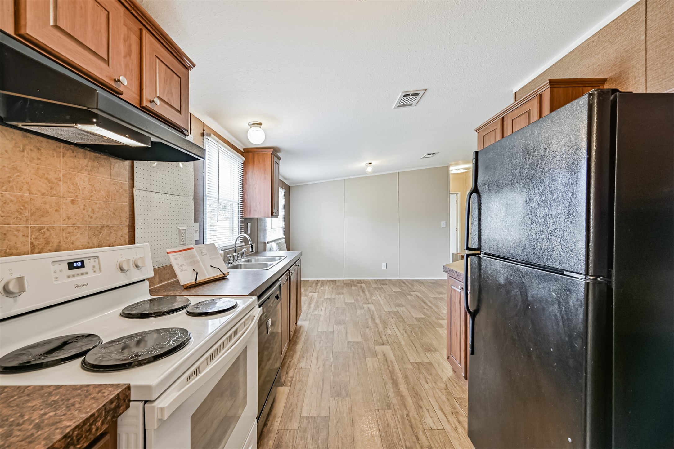 1036 9th Street Dickinson, TX 77539 - Photo 15 of 29 a kitchen with stainless steel appliances a refrigerator and a stove top oven