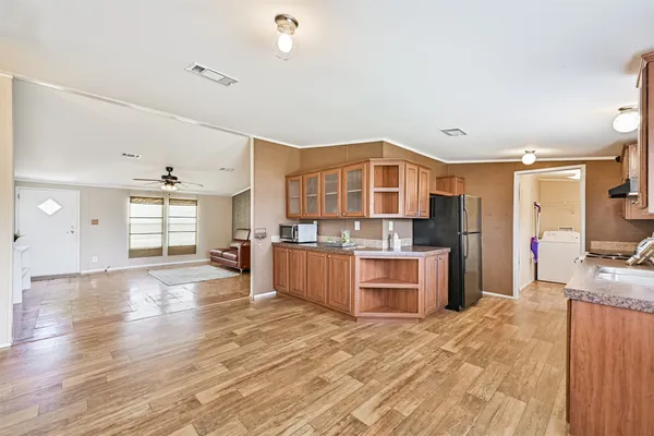a large kitchen with stainless steel appliances granite countertop a stove and cabinets