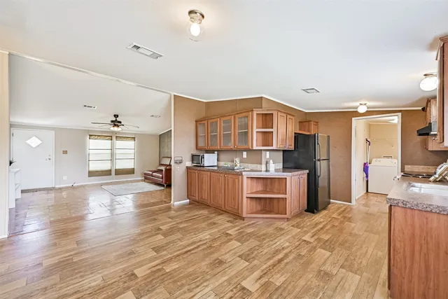 a large kitchen with stainless steel appliances granite countertop a stove and cabinets