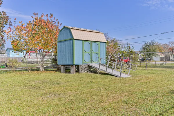 a view of swimming pool with outdoor seating and house in the background