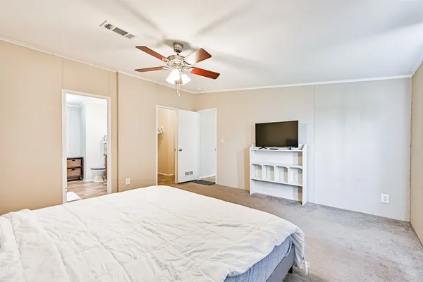 a bedroom with a bed and a flat screen tv