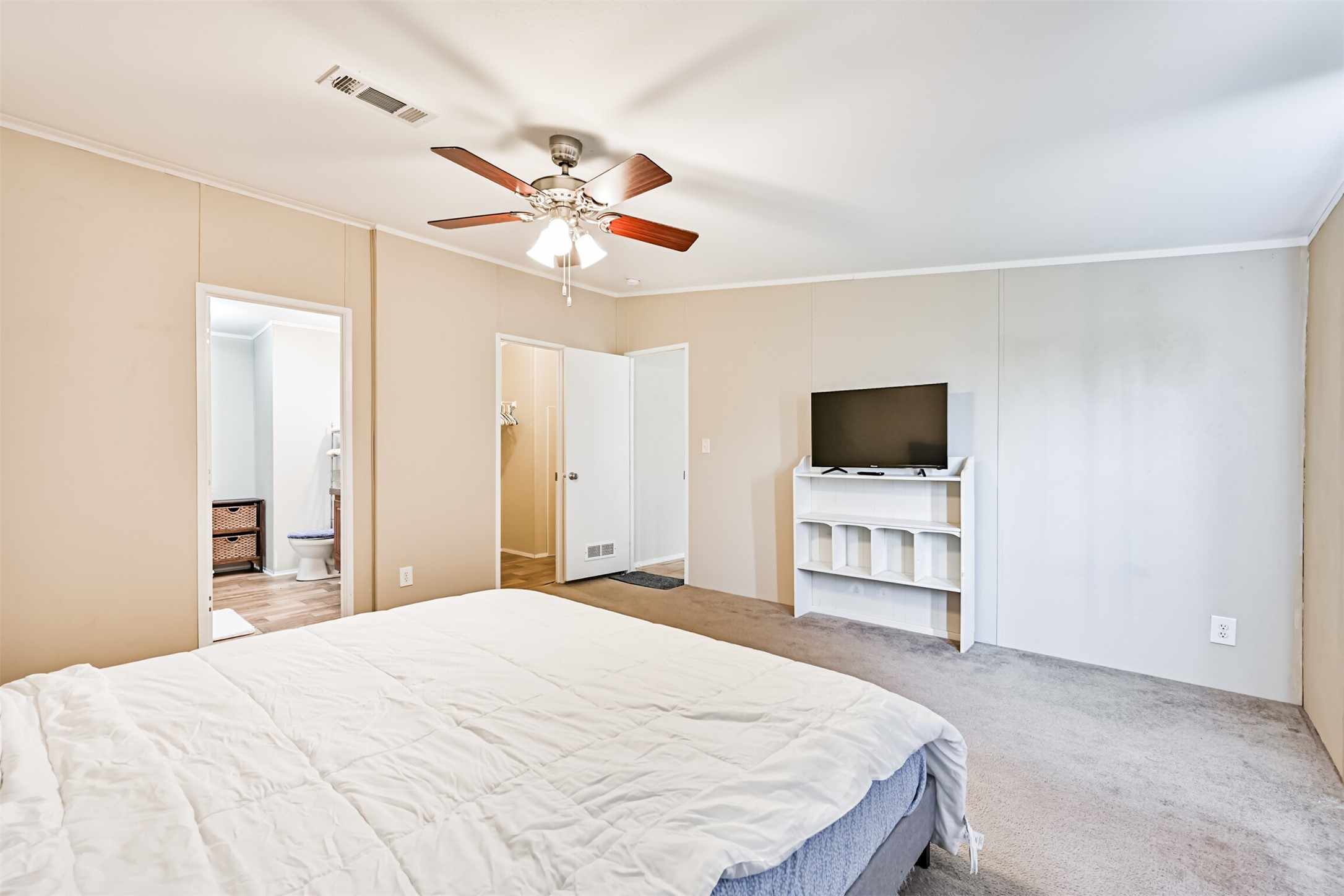 1036 9th Street Dickinson, TX 77539 - Photo 8 of 29 a bedroom with a bed and a flat screen tv