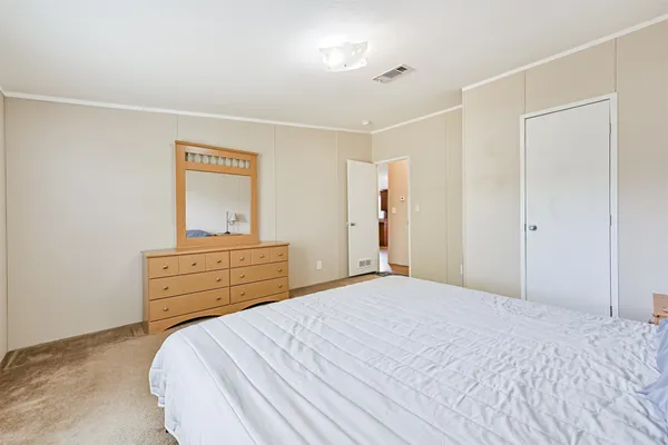 a bedroom with a bed and a dresser