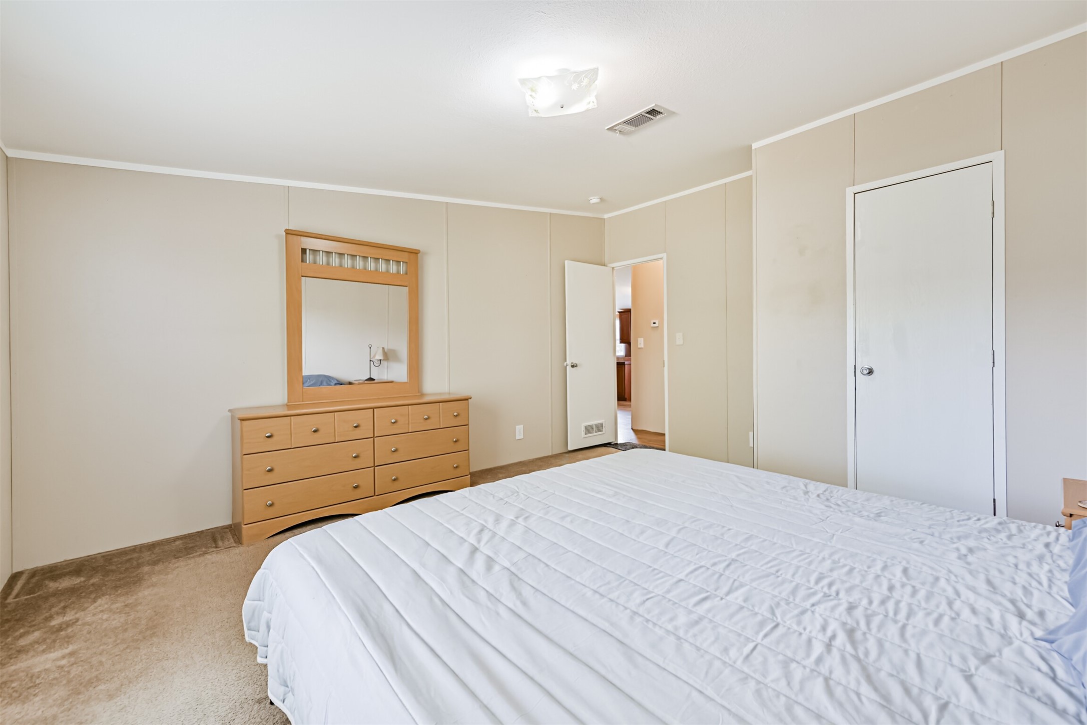 1036 9th Street Dickinson, TX 77539 - Photo 10 of 29 a bedroom with a bed and a dresser