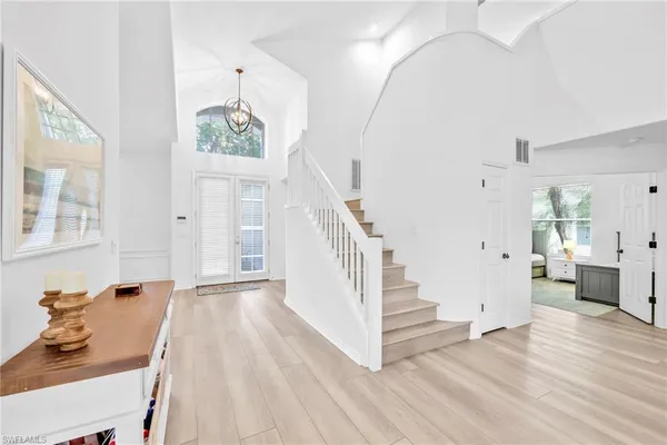 a view of a livingroom with wooden floor and furniture