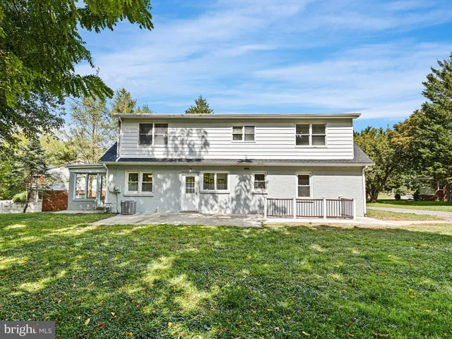 a front view of a house with a yard table and chairs