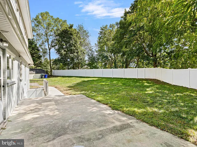 a view of yard with swimming pool and green space