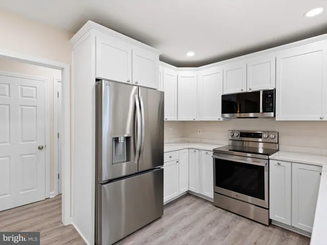 a kitchen with stainless steel appliances a refrigerator stove and microwave