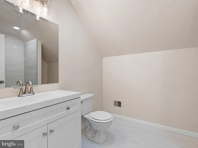 a bathroom with a sink a toilet and vanity