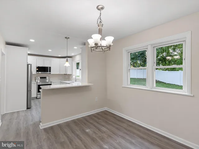a view of a kitchen with a dishwasher cabinets and a large window