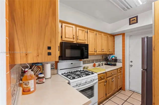 a kitchen with a stove a sink and a microwave