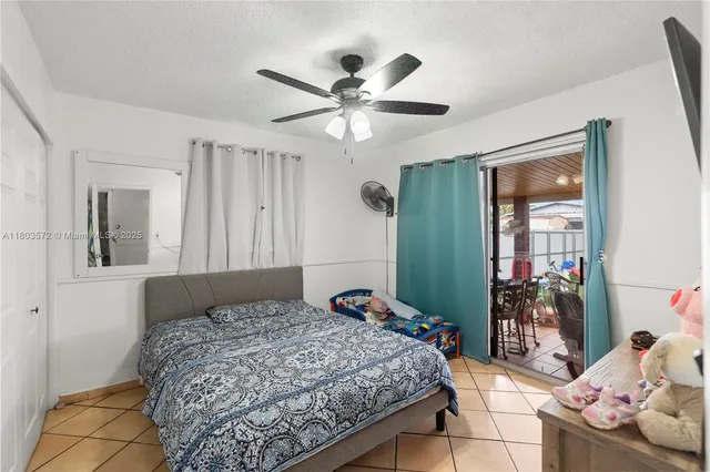 a bedroom with a bed and ceiling fan