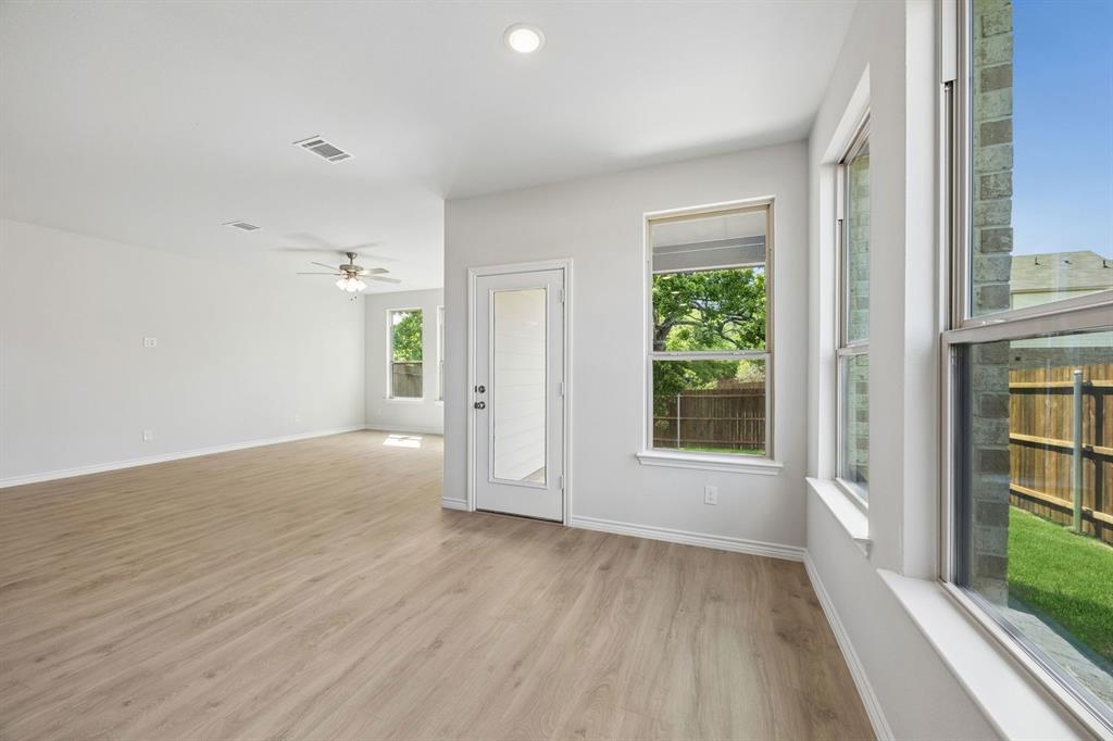 504-506 Mockingbird Lane Denton, TX 76209 - Photo 11 of 30 wooden floor in an empty room with a window