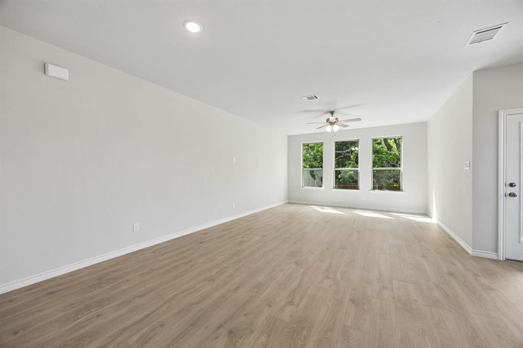 504-506 Mockingbird Lane Denton, TX 76209 - Photo 12 of 30 wooden floor in an empty room with a window