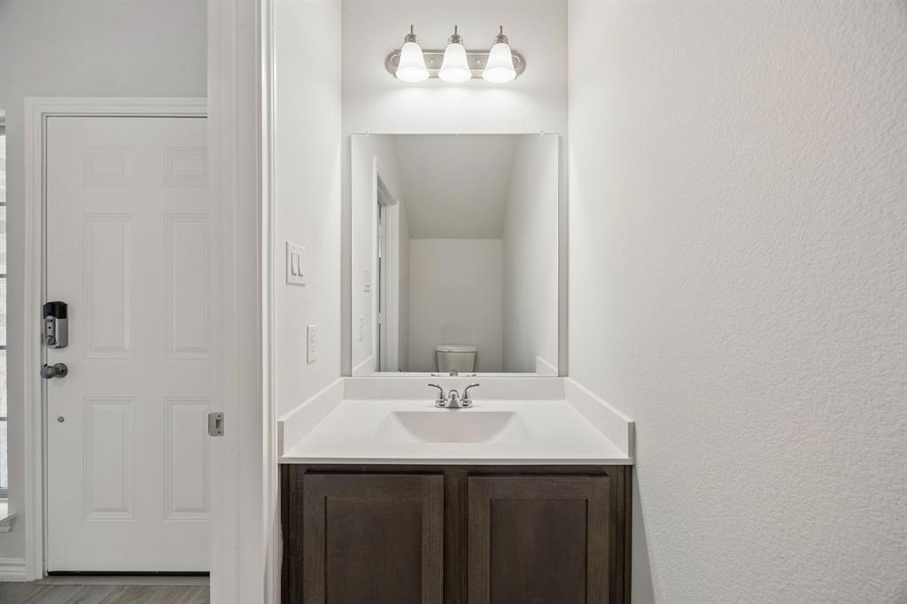504-506 Mockingbird Lane Denton, TX 76209 - Photo 15 of 30 a bathroom with a sink and a mirror