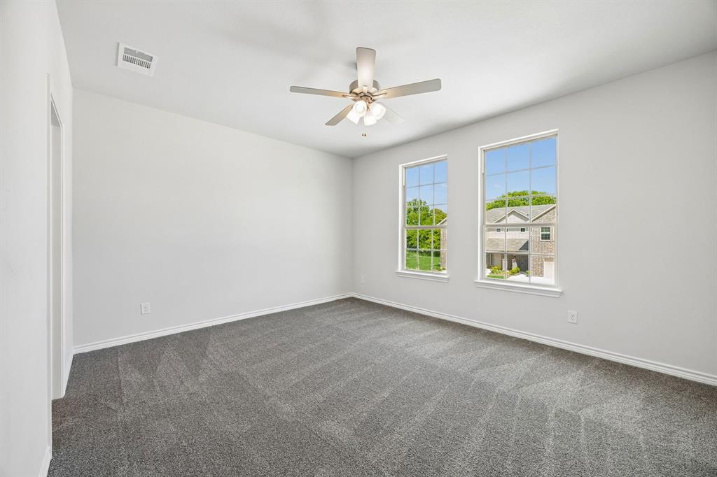 504-506 Mockingbird Lane Denton, TX 76209 - Photo 16 of 30 an empty room with windows and ceiling fan
