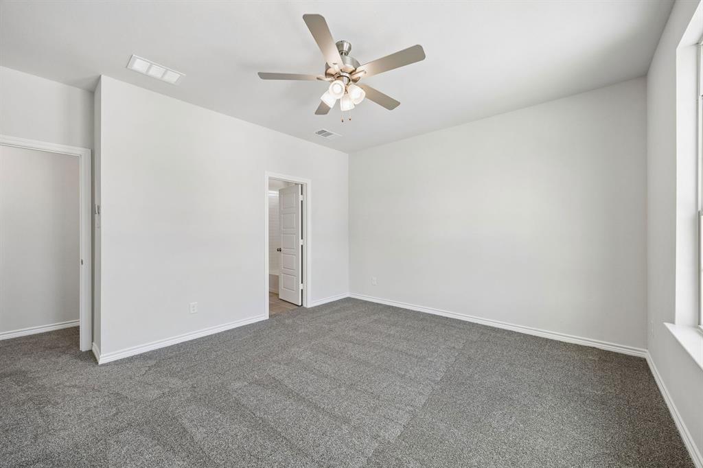 504-506 Mockingbird Lane Denton, TX 76209 - Photo 17 of 30 an empty room with closet and ceiling fan