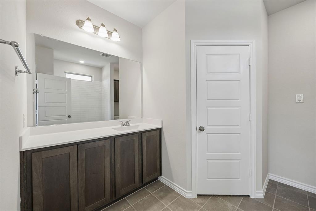 504-506 Mockingbird Lane Denton, TX 76209 - Photo 19 of 30 a bathroom with a double vanity sink and a mirror
