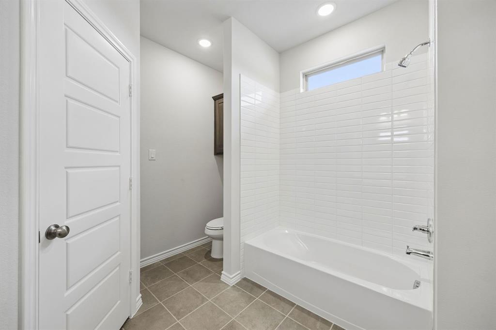 504-506 Mockingbird Lane Denton, TX 76209 - Photo 20 of 30 a bathroom with a bathtub and a shower