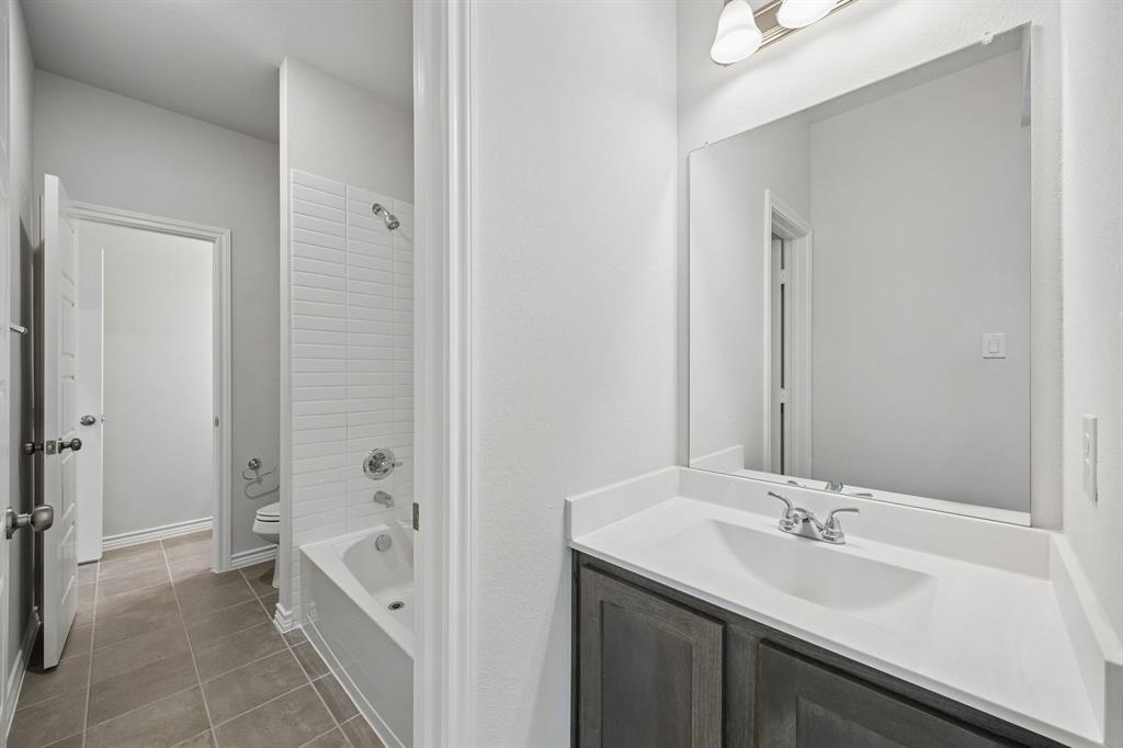 504-506 Mockingbird Lane Denton, TX 76209 - Photo 25 of 30 a bathroom with a tub sink and mirror