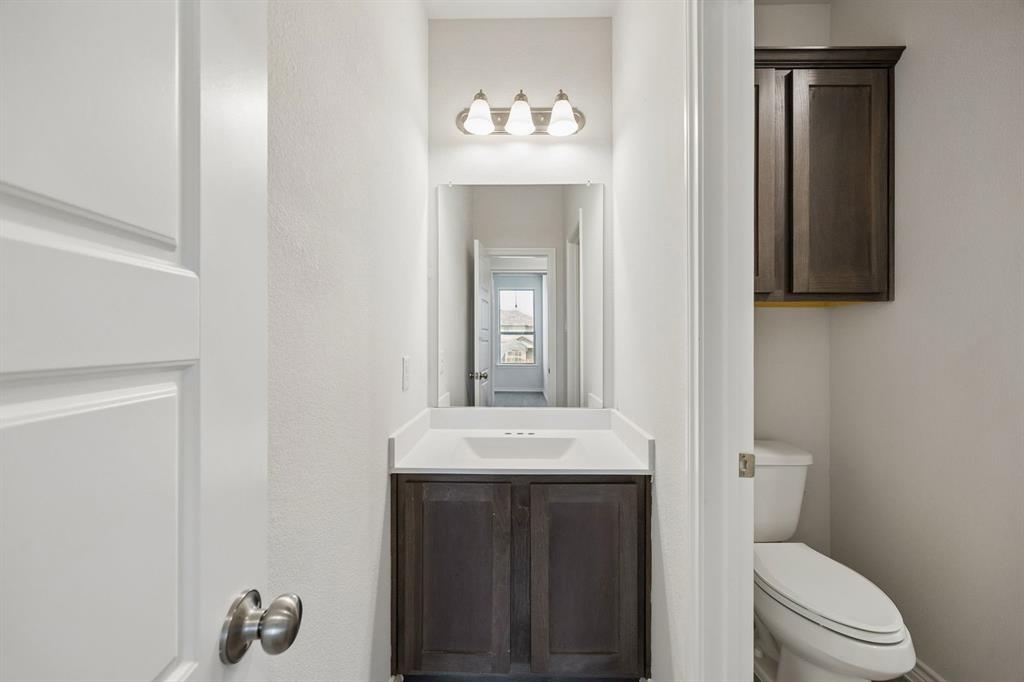 504-506 Mockingbird Lane Denton, TX 76209 - Photo 27 of 30 a bathroom with a toilet sink and mirror